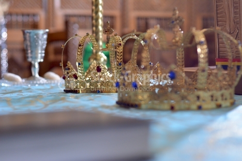 Golden crown decorated with blue and red precious stones. Orthodox church