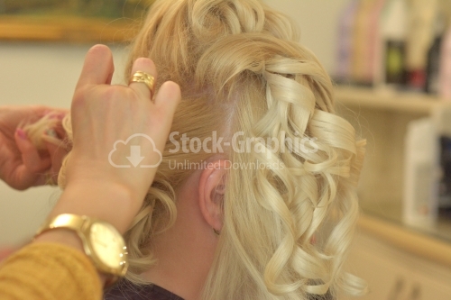 Hairdresser working on a blonde woman