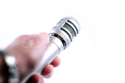 Hand holding microphone on white background 