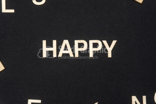 HAPPY word written on dark paper background. HAPPY text for your concepts