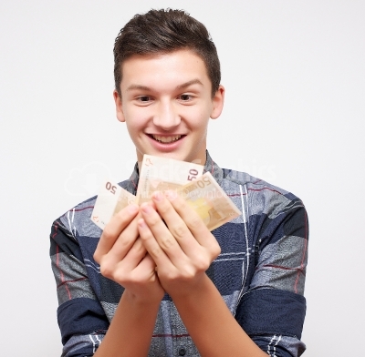 Happy young man  showing money while standing isolated on white