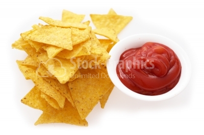 Healthy snack tortilla chips or corn chips, with tomato ketchup.