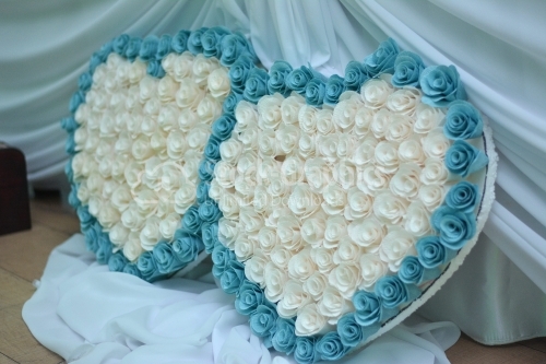 Heart made of flowers on a blue background