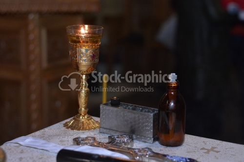 Holy cross, candle and oil prepared for the baptism ceremony