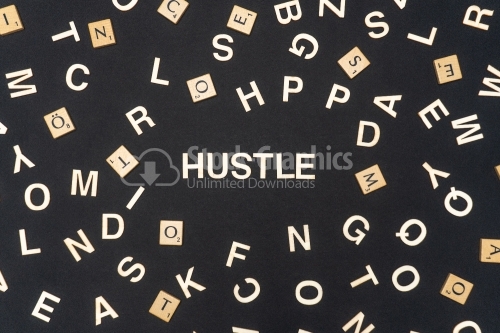 HUSTLE word written on dark paper background. HUSTLE text for your concepts