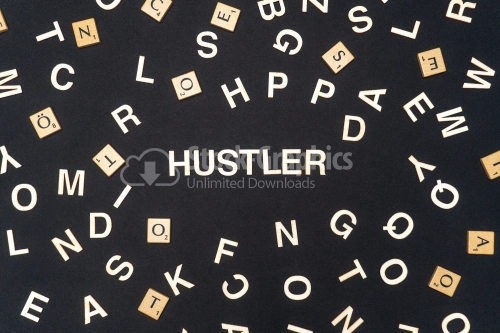 HUSTLER word written on dark paper background. HUSTLER text for your concepts