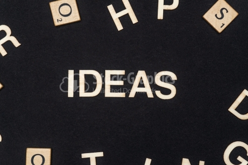 IDEAS word written on dark paper background. IDEAS text for your concepts