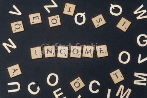 INCOME word written on dark paper background. INCOME text for your concepts