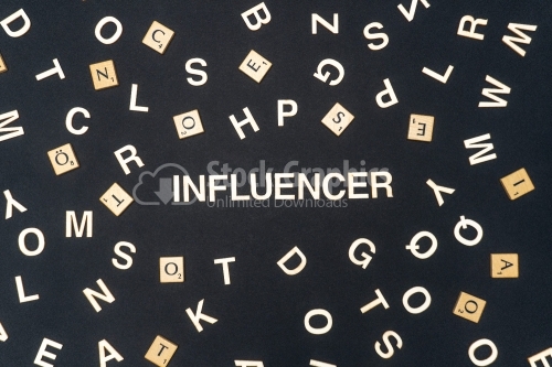 INFLUENCER word written on dark paper background. INFLUENCER text for your concepts