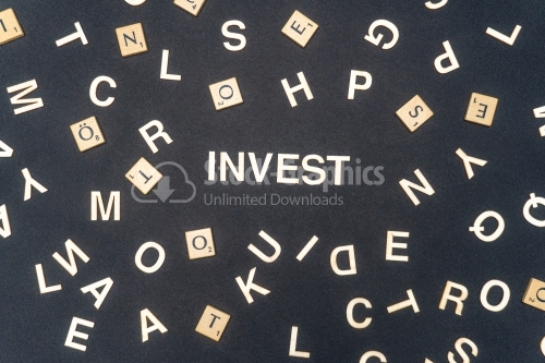 INVEST word written on dark paper background. INVEST text for your concepts