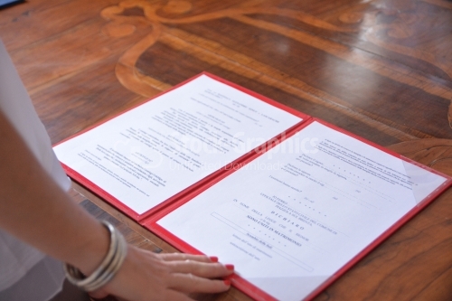 Italian marriage certificate on wooden table