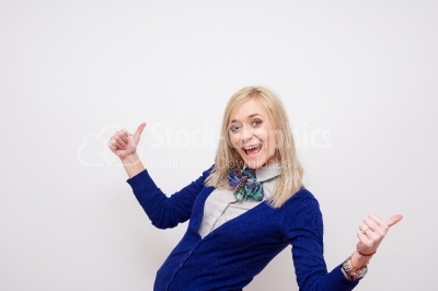 Joyous, young woman celebrating success against white background