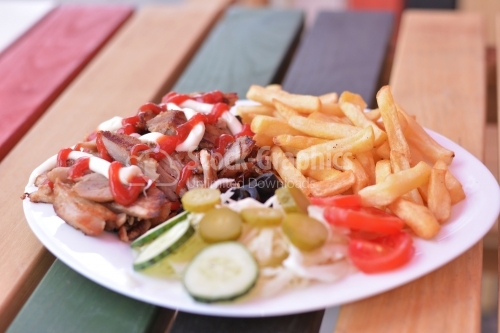 Kebab sandwich on white plate.