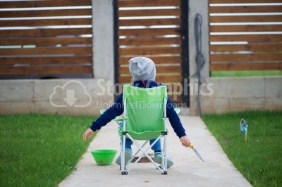 Kid sitting on a small bench