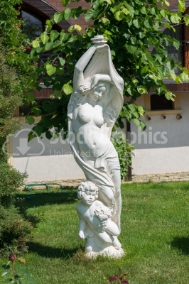 Marble Statue in front of a tree 