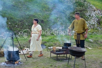 Medieval family preparing food at festival
