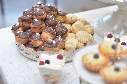 Mini chocolate covered eclairs and almond cookies