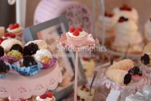 Mini tart with raspberry and raspberry sitting on a pedestal
