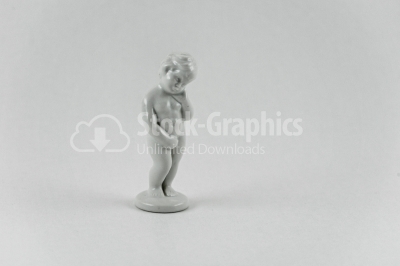 Naked kid porcelain statuette on white background