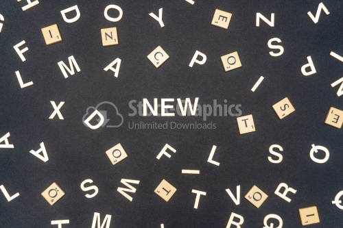 NEW word written on dark paper background. NEW text for your concepts