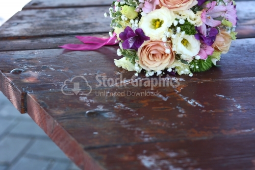 Nice bouquet of flowers placed on a old wood table