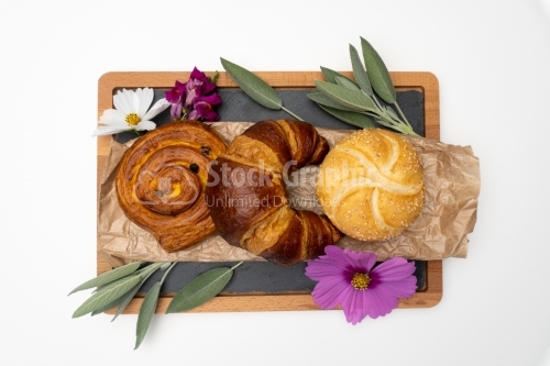 Nice flowers and breads on a dark cooking board