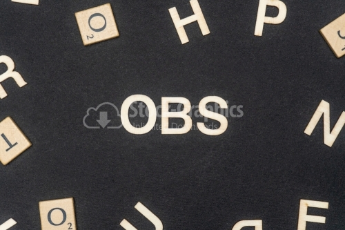 OBS word written on dark paper background. OBS text for your concepts