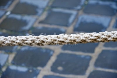 Old rope with pavement background