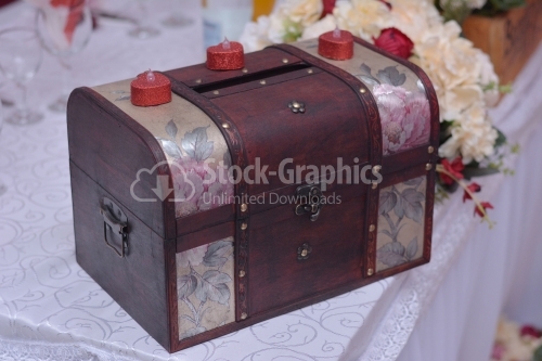 Old wedding coffer for money with red candles
