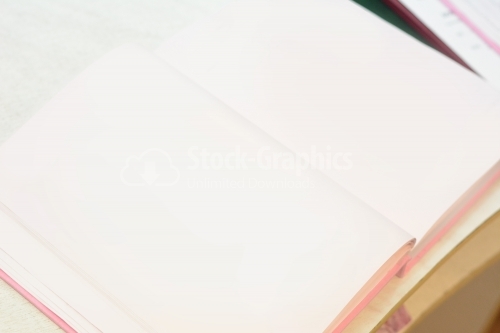 Open notebook with white background on the table