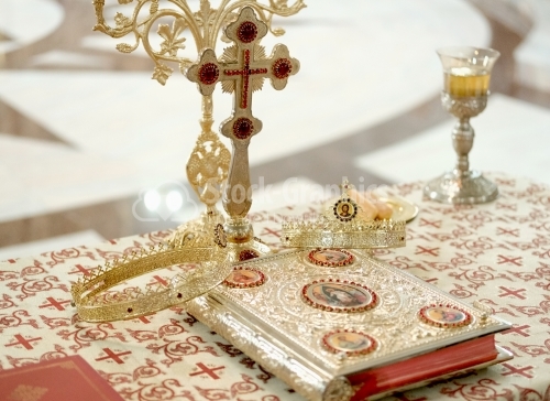 Orthodox book and crowns for romanian wedding ceremony in church