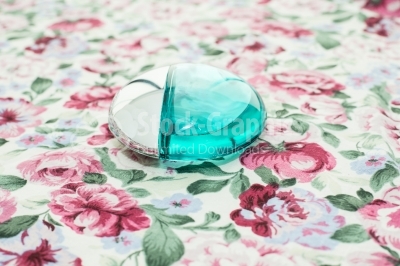 Perfume bottle on a table with a floral background