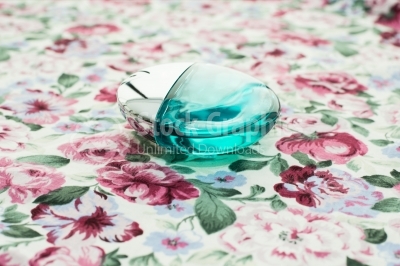 Perfume bottle on floral background