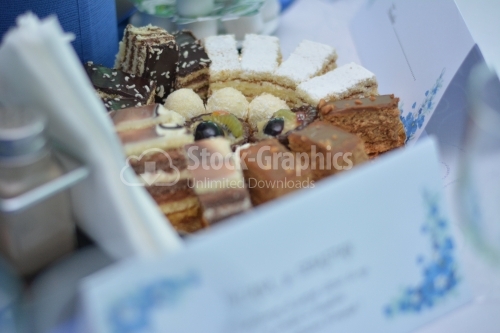 Plateau with fruits tarts, cocoa cakes and vanilla cakes