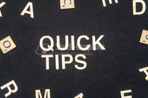 QUICK TIPS word written on dark paper background. QUICK TIPS text for your concepts