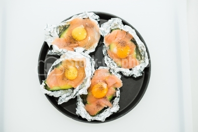 Raw eggs on pieces of salmon
