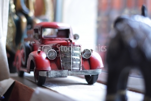 Red vintage toy car in a boutique.
