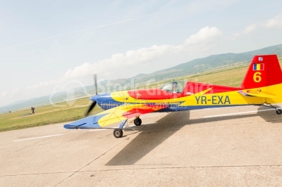 Romanian-flag-coloured propeller plane landing