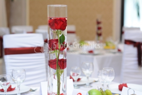 Rose placed in a vase with water on a wedding table