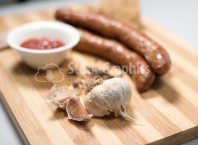 Sausages on wood plate