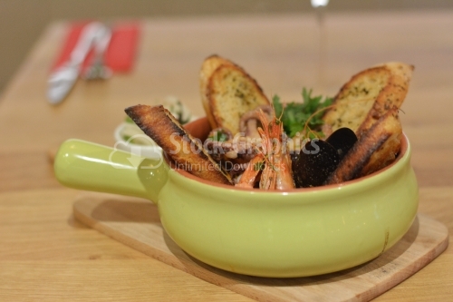 Seafood and toast with aromatic oils.