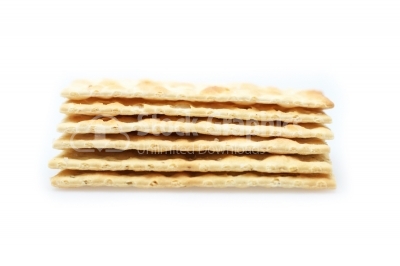 Stack of vegetable salty crackers on white background