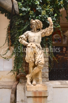 Statue in front of beautiful Peles castle