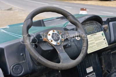 Steering wheel in rusty, old interior of ruined car