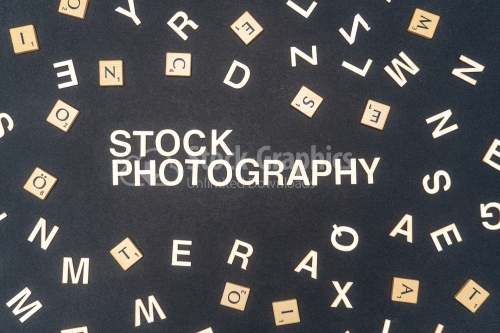 STOCK PHOTOGRAPHY word written on dark paper background. STOCK PHOTOGRAPHY text for your concepts