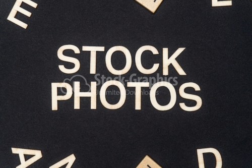 STOCK PHOTOS word written on dark paper background. STOCK PHOTOS text for your concepts