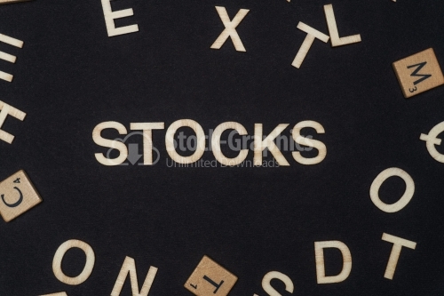 STOCKS word written on dark paper background. STOCKS text for your concepts
