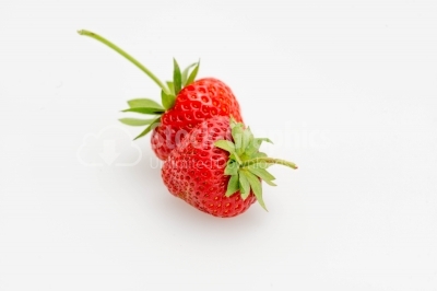 Strawberries with green leaves on white background close-up