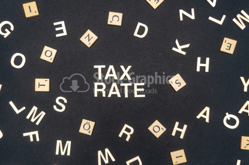 TAX RATE word written on dark paper background. TAX RATE text for your concepts
