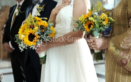 The bride and groom in the church. The sunflower is part of the wedding theme.nd groom in the church.
